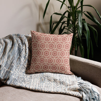 18″×18″ premium throw pillow with the ‘Decagon’ terracotta and beige geometric pattern on a beige sofa with a woven throw.