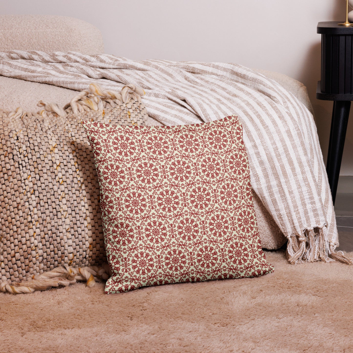 18″×18″ premium throw pillow with the ‘Decagon’ terracotta and beige geometric pattern on a bedroom floor with striped linen throws.