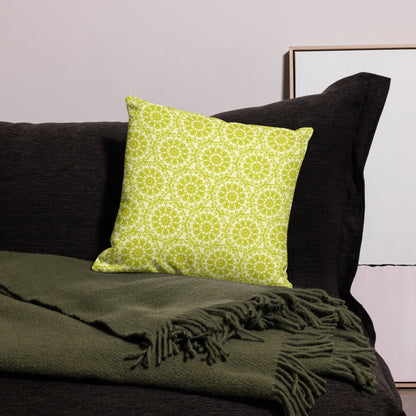 18″×18″ premium throw pillow with the 'Hendecagon' yellow-green geometric pattern on a dark sofa with green throw