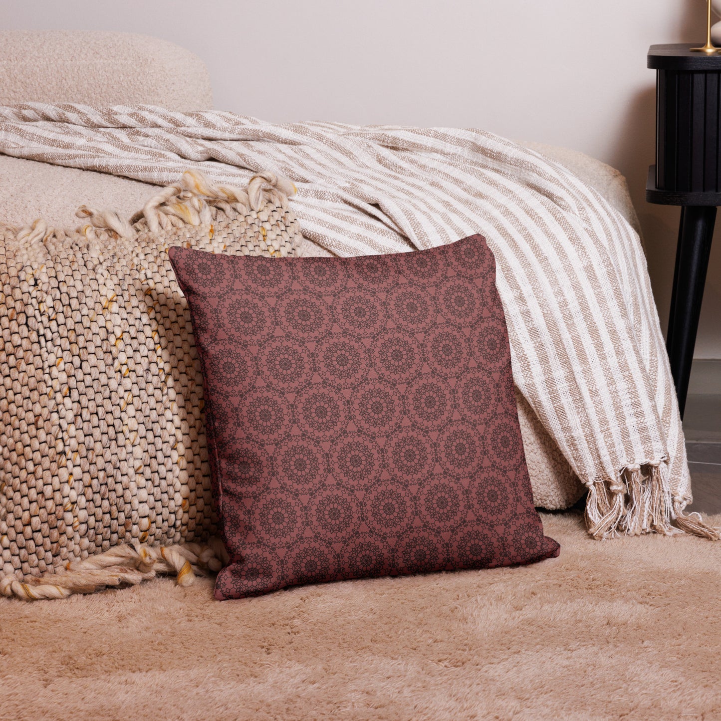 18″×18″ premium throw pillow with the 'Dodecagon' rose geometric pattern on carpet beside bed with striped throw.