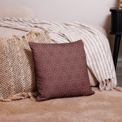 18″×18″ premium throw pillow with the 'Dodecagon' rose geometric pattern on carpet beside bed with striped throw.