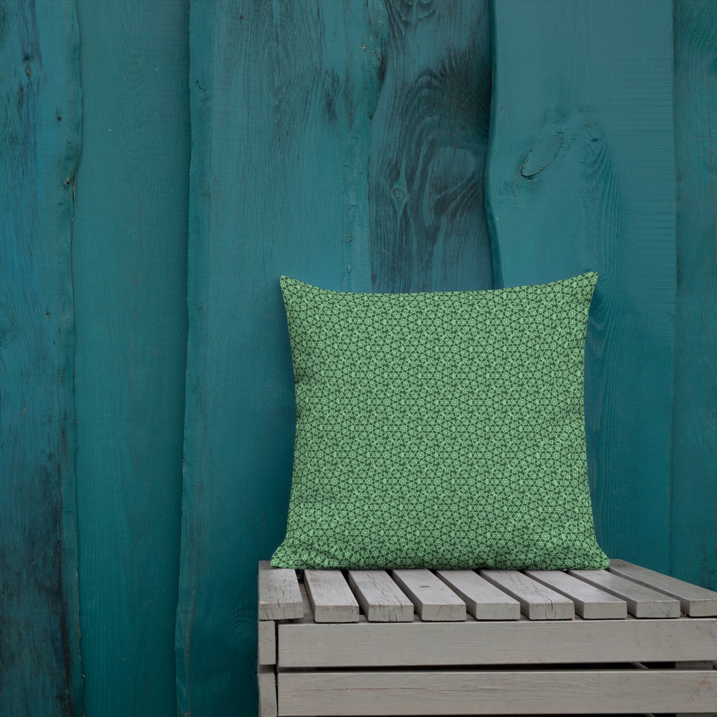 18″×18″ premium throw pillow with the 'Heptagon' green geometric pattern shown in a lifestyle setting.