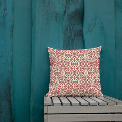 18″×18″ premium throw pillow with the ‘Decagon’ terracotta and beige geometric pattern on an outdoor bench with a teal wooden backdrop.