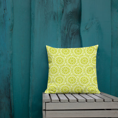 18″×18″ premium throw pillow with the 'Hendecagon' yellow-green geometric pattern on a wooden bench with teal wall