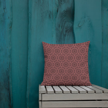 18″×18″ premium throw pillow with the 'Dodecagon' rose geometric pattern on wooden bench against teal painted wall.