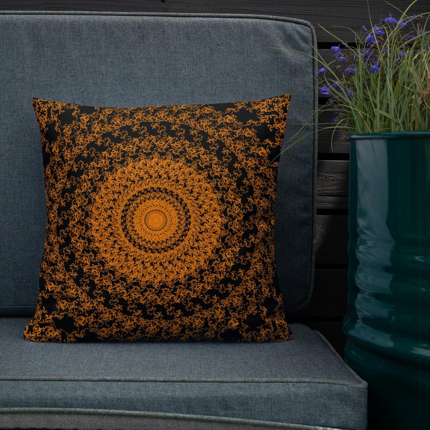 18″×18″ premium throw pillow with the 'The Sun' orange and black geometric design shown in a lifestyle setting.