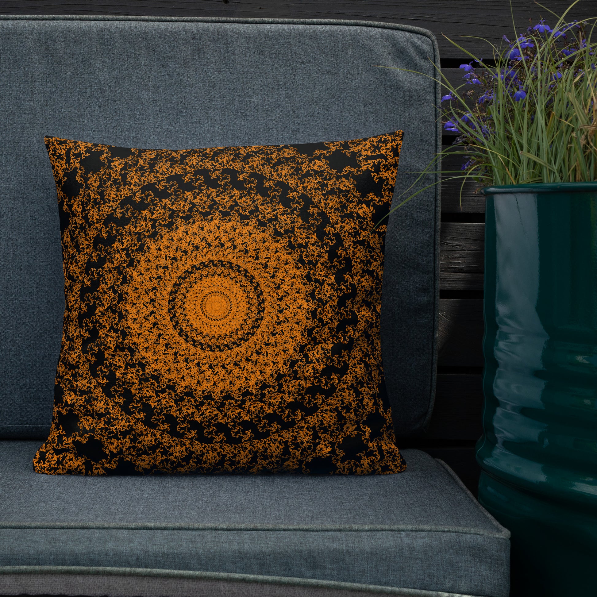 18″×18″ premium throw pillow with the 'The Sun' orange and black geometric design shown in a lifestyle setting.