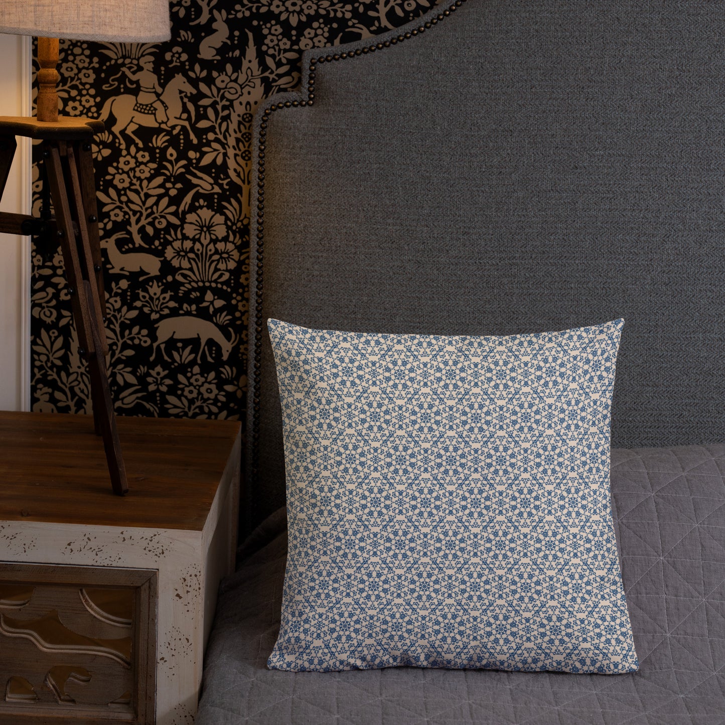 18″×18″ premium throw pillow with the ‘Octagon’ navy and beige geometric pattern on a bed with upholstered headboard.