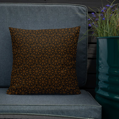 18″×18″ premium throw pillow with the 'Enneagon' black & gold geometric pattern on an outdoor sofa with dark slat wall.