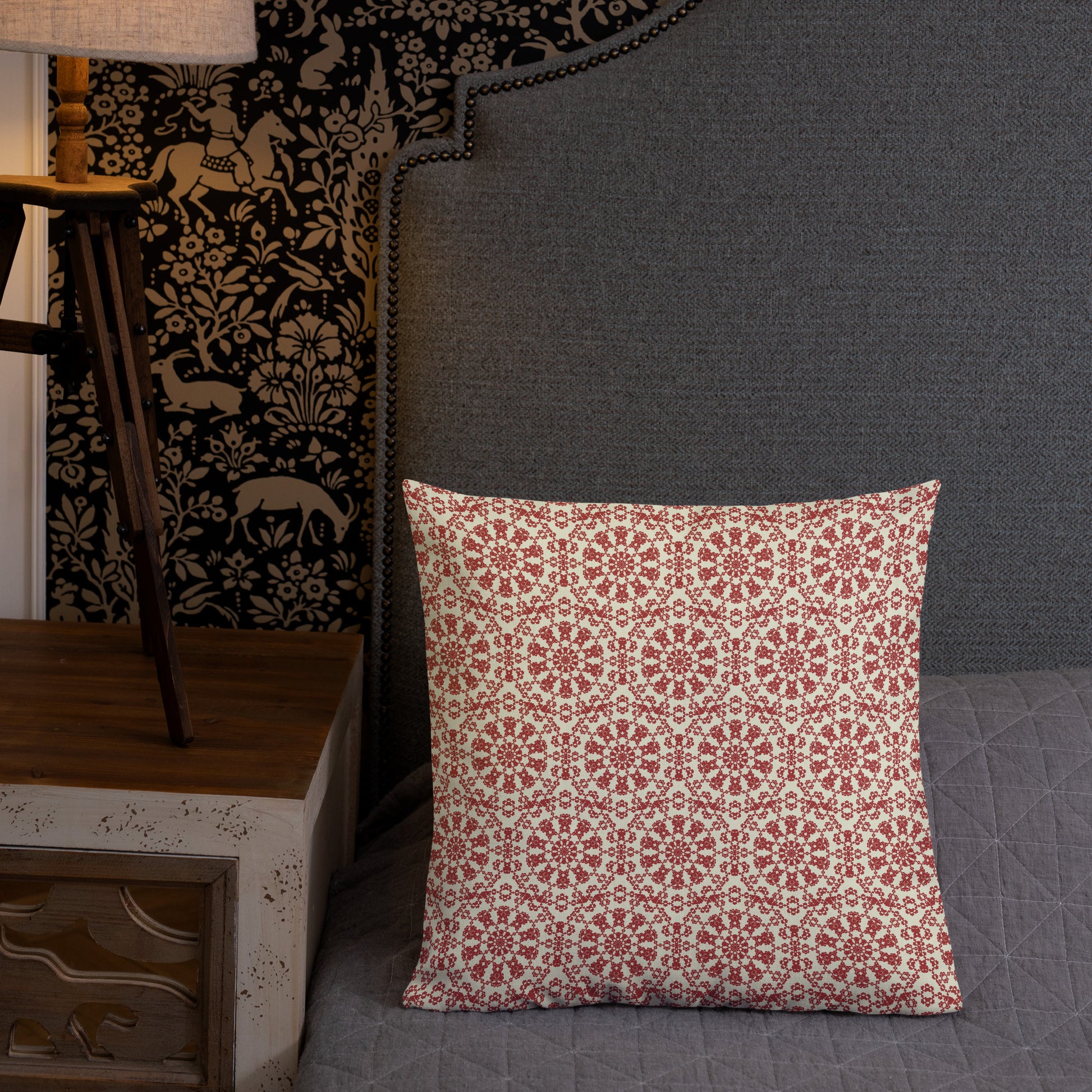 18″×18″ premium throw pillow with the ‘Decagon’ terracotta and beige geometric pattern on a grey bed with an ornate headboard.