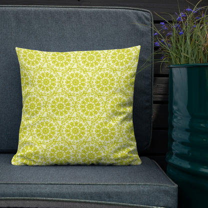 18″×18″ premium throw pillow with the 'Hendecagon' yellow-green geometric pattern on an outdoor sofa with teal planter