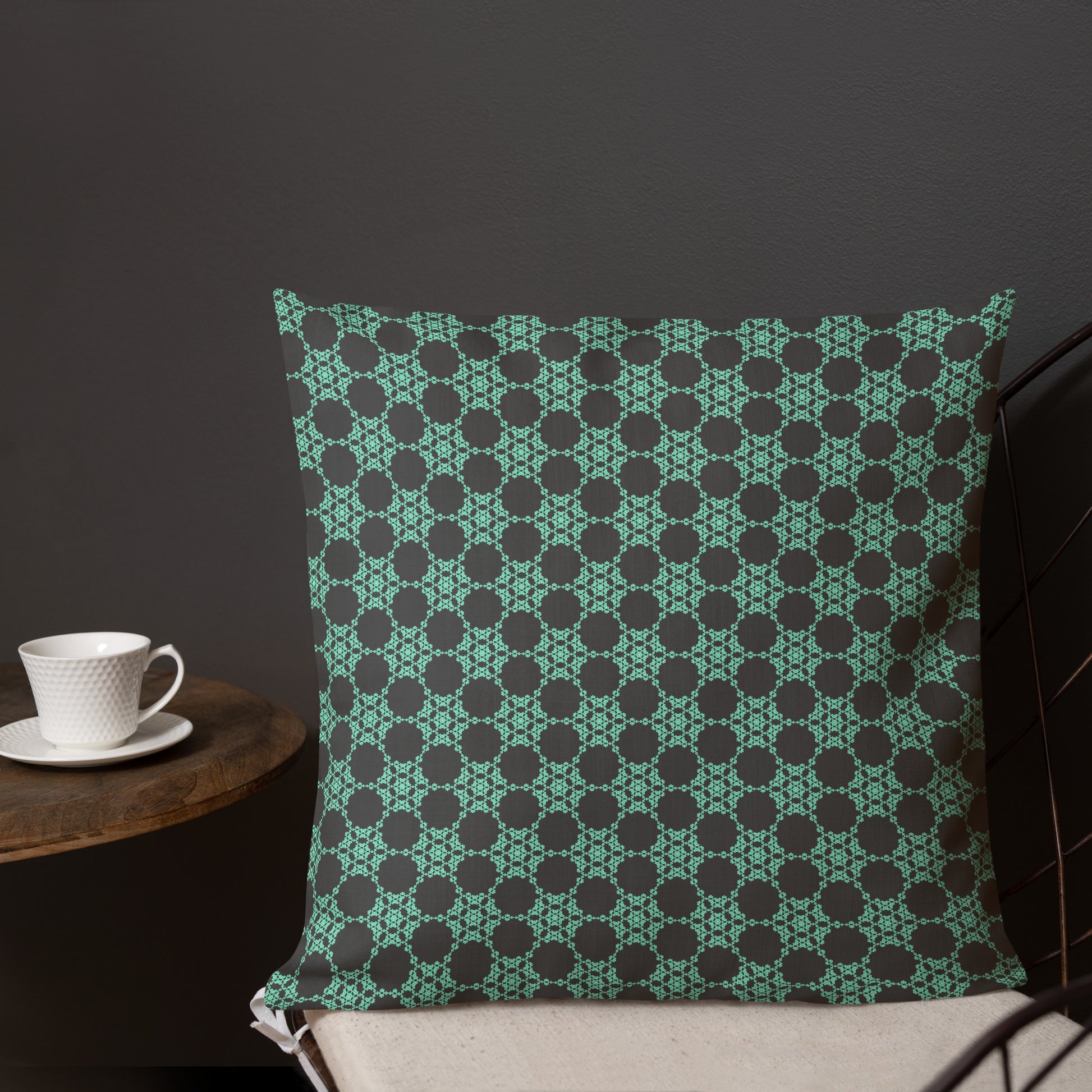 18″×18″ premium throw pillow with the 'Flowers Victory' charcoal and mint geometric pattern shown in a lifestyle setting.