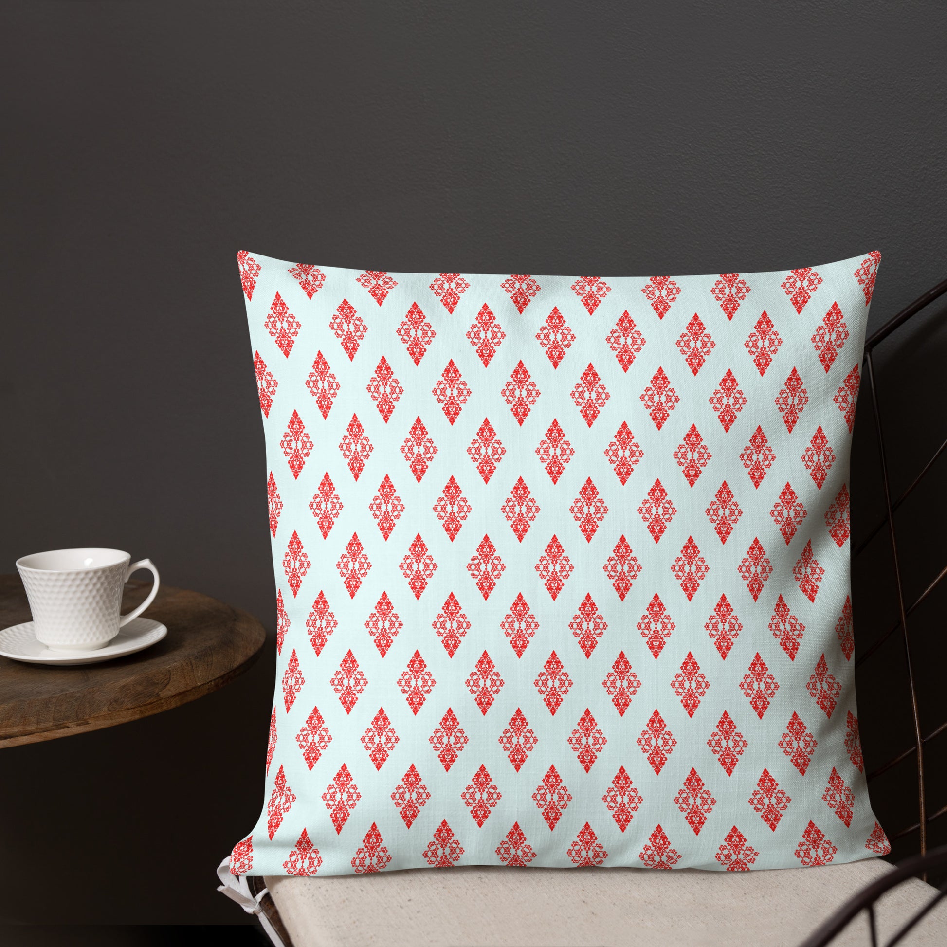 18″×18″ premium throw pillow with the 'Digon' sky blue and red geometric pattern shown in a lifestyle setting.