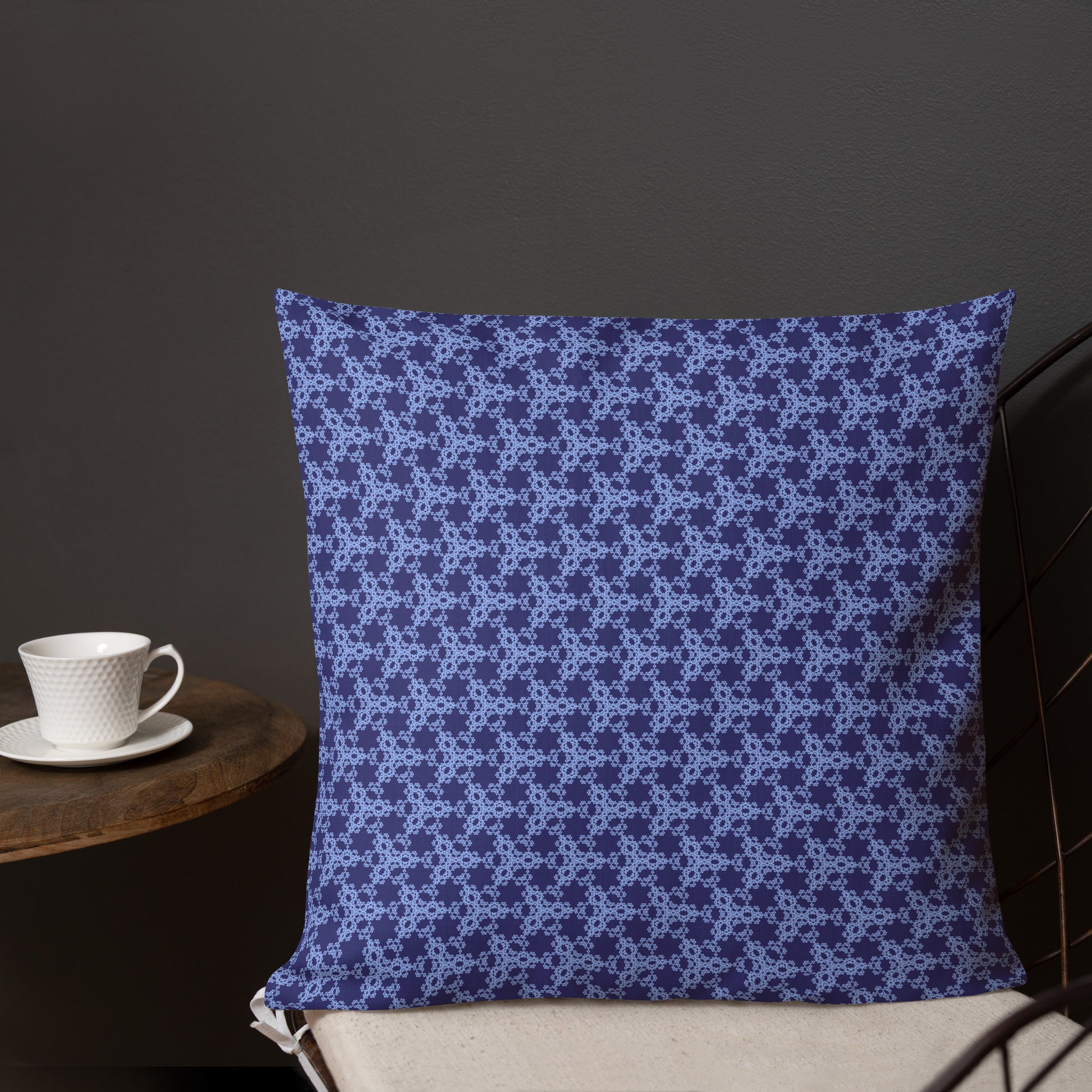 18″×18″ premium throw pillow with the 'Trigon' navy and blue geometric pattern shown in a lifestyle setting.