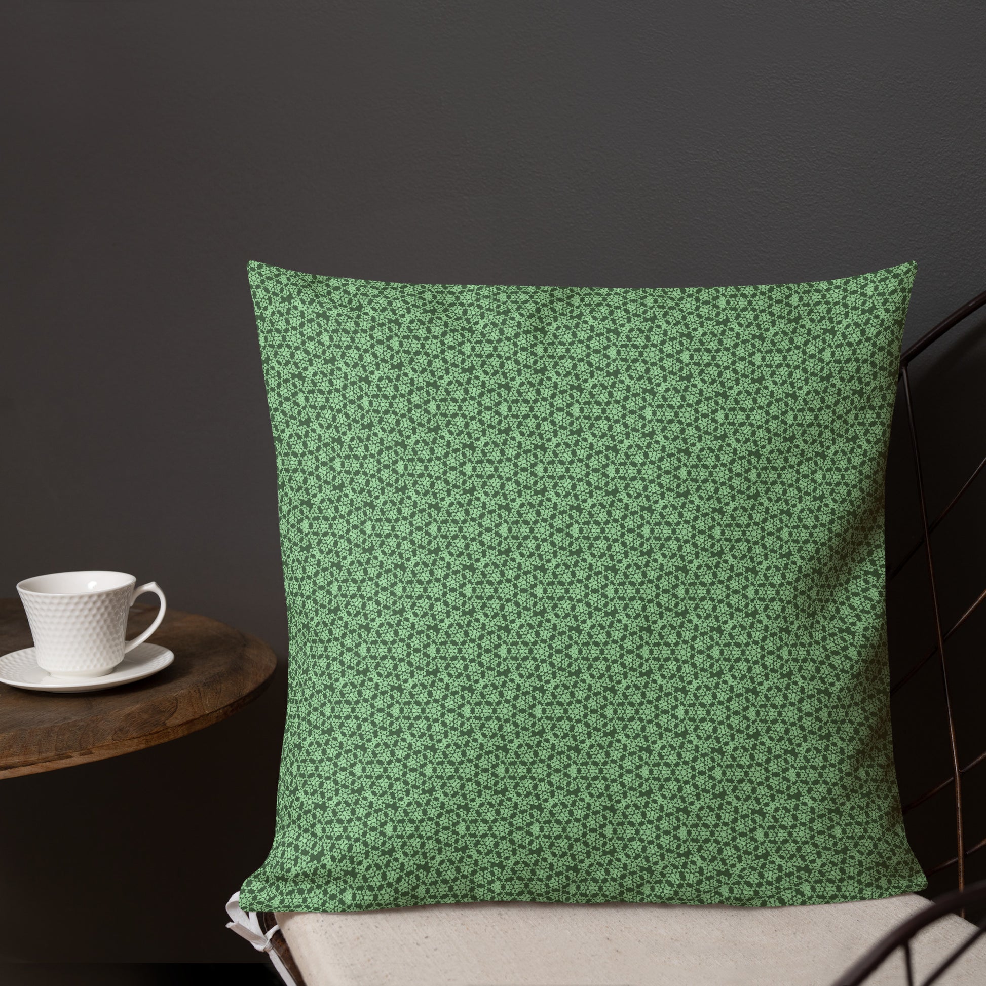 18″×18″ premium throw pillow with the 'Heptagon' green geometric pattern shown in a lifestyle setting.