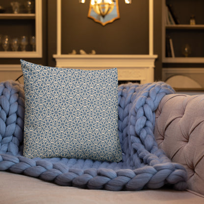 18″×18″ premium throw pillow with the ‘Octagon’ navy and beige geometric pattern on a sofa with chunky knit blanket.