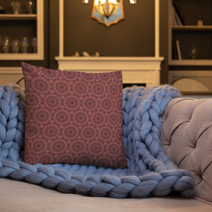 18″×18″ premium throw pillow with the 'Dodecagon' rose geometric pattern on tufted sofa with chunky blue knit blanket.