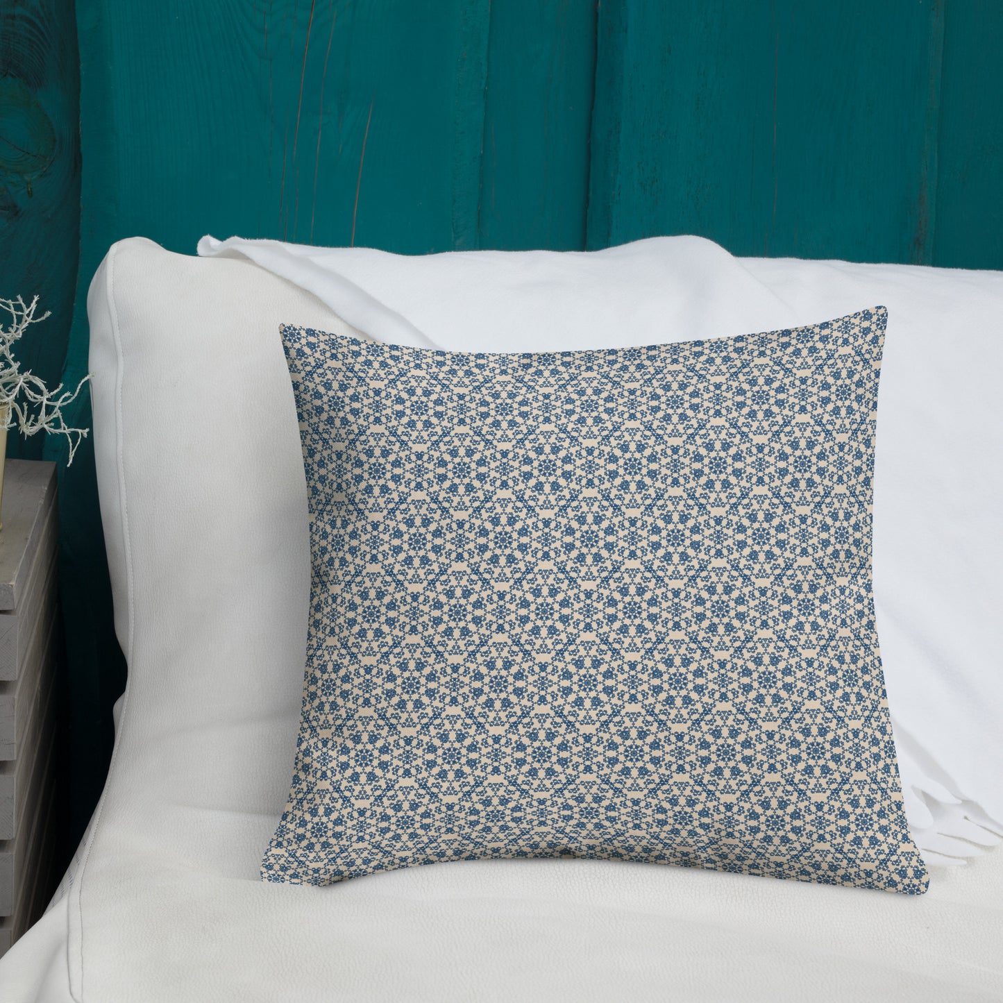 18″×18″ premium throw pillow with the ‘Octagon’ navy and beige geometric pattern on a white sofa with teal wooden wall.