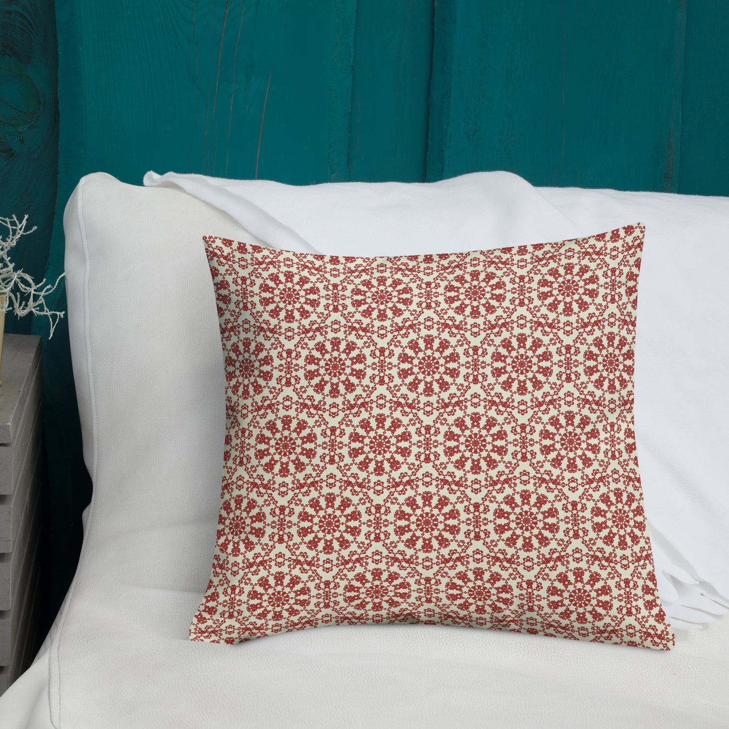 18″×18″ premium throw pillow with the ‘Decagon’ terracotta and beige geometric pattern on a white bed with a teal wooden headboard.