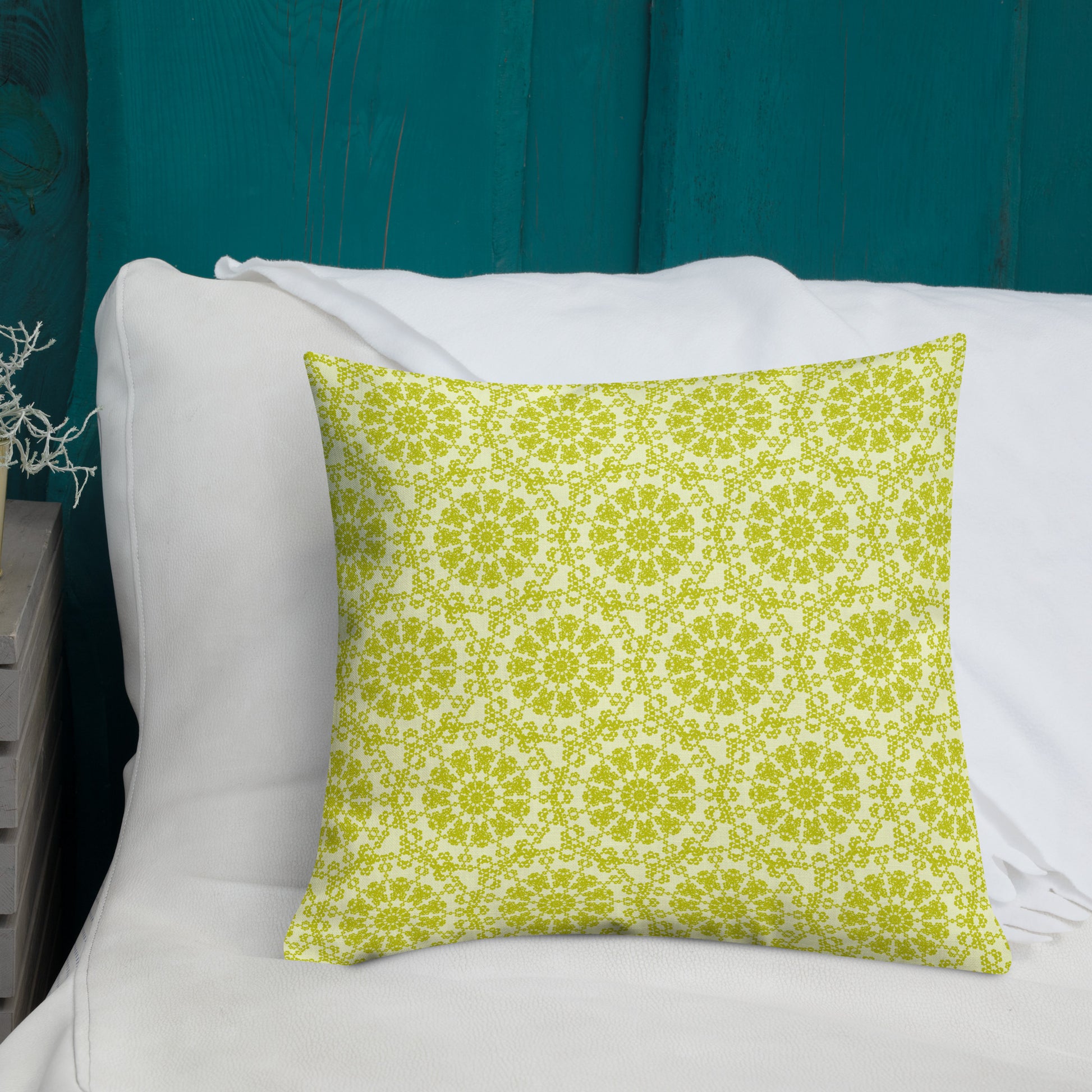 18″×18″ premium throw pillow with the 'Hendecagon' yellow-green geometric pattern on a bed with teal headboard