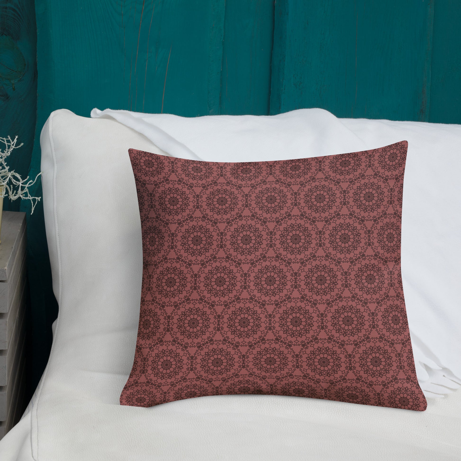 18″×18″ premium throw pillow with the 'Dodecagon' rose geometric pattern on white sofa with teal wooden wall.