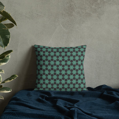18″×18″ premium throw pillow with the 'Flowers Victory' charcoal and mint geometric pattern on a bed.