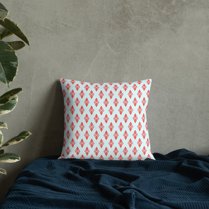 18″×18″ premium throw pillow with the 'Digon' sky blue and red geometric pattern on a bed.