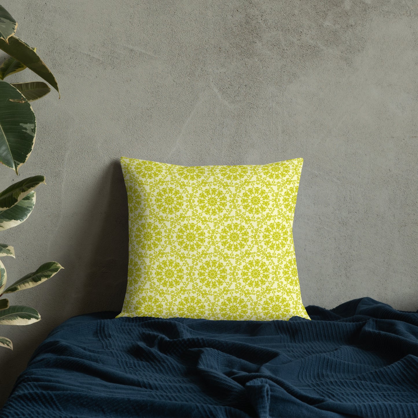 18″×18″ premium throw pillow with the 'Hendecagon' yellow-green geometric pattern on a bed with concrete wall