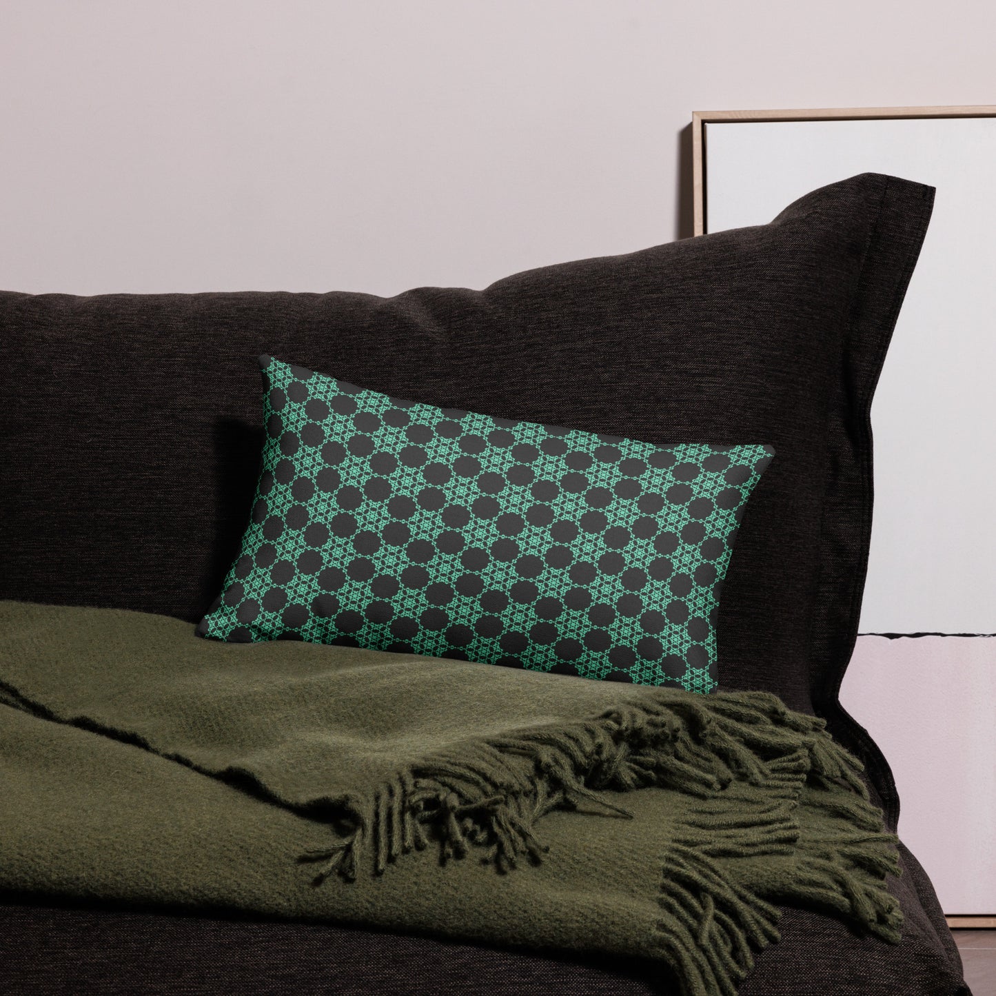 20″×12″ premium throw pillow with the 'Flowers Victory' charcoal and mint geometric pattern on a couch.