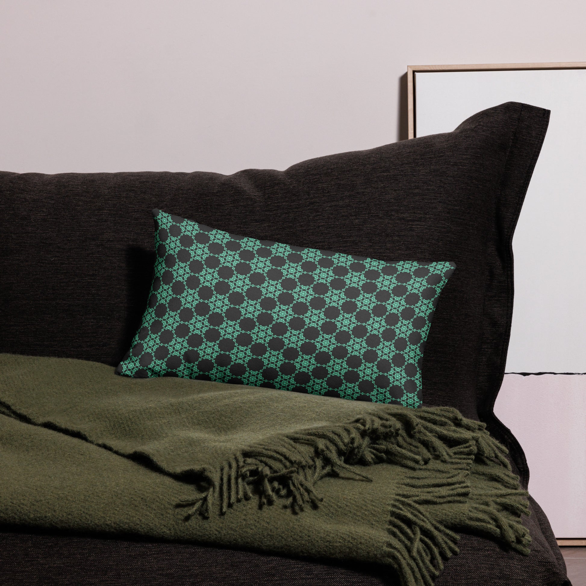 20″×12″ premium throw pillow with the 'Flowers Victory' charcoal and mint geometric pattern on a couch.