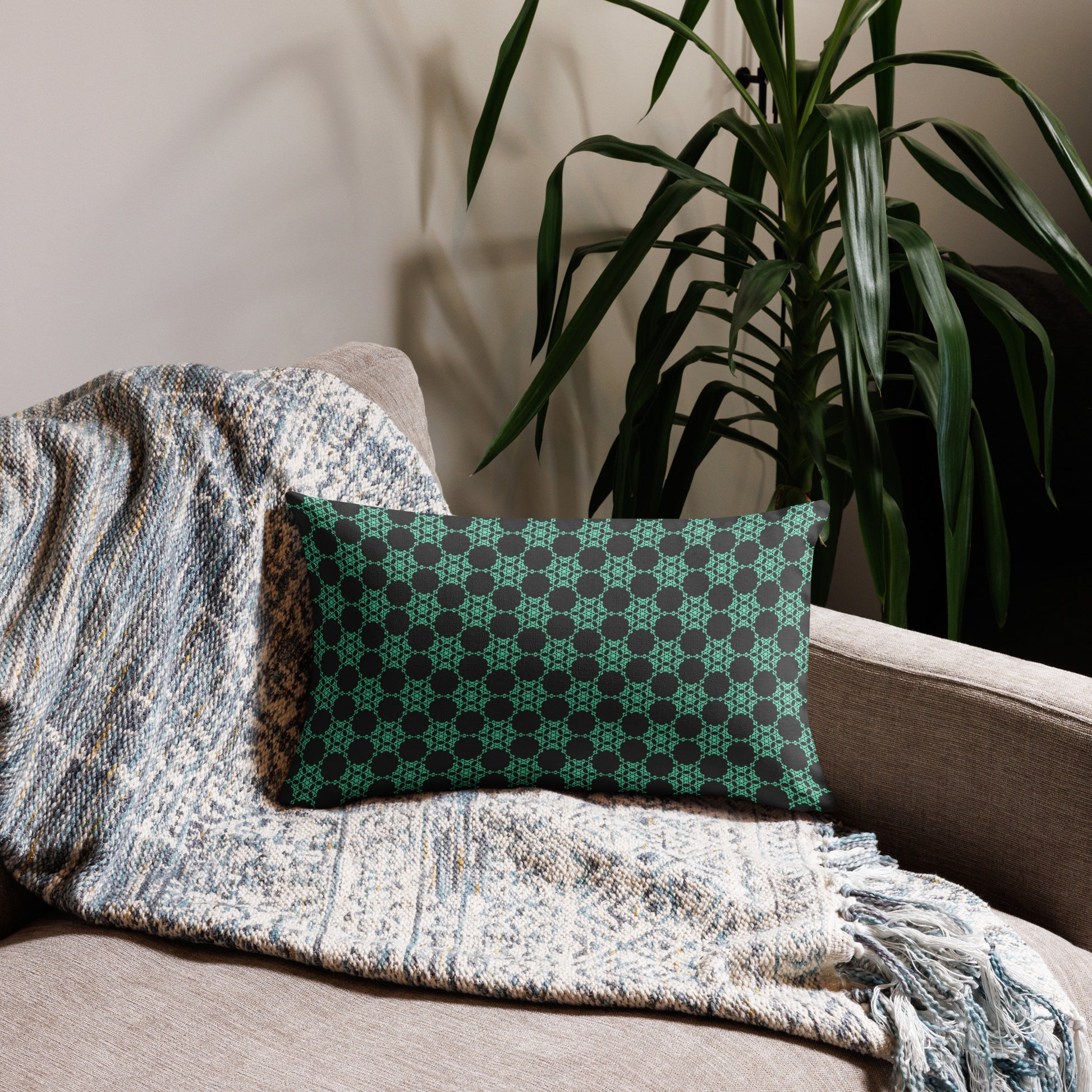 20″×12″ premium throw pillow with the 'Flowers Victory' charcoal and mint geometric pattern on a couch.
