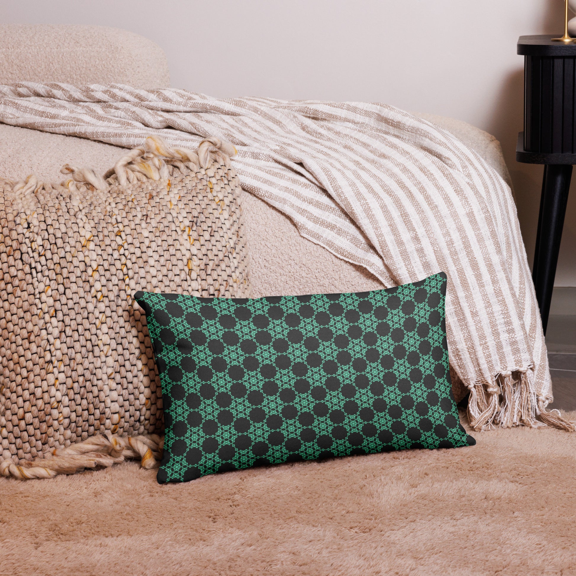 20″×12″ premium throw pillow with the 'Flowers Victory' charcoal and mint geometric pattern on a couch.