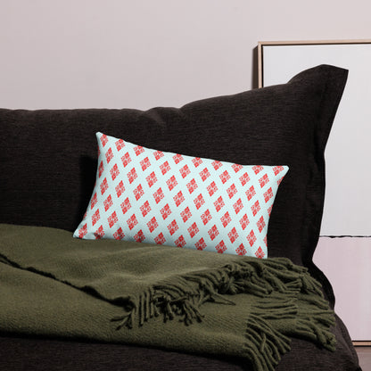 20″×12″ premium throw pillow with the 'Digon' sky blue and red geometric pattern on a couch.