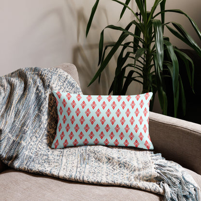 20″×12″ premium throw pillow with the 'Digon' sky blue and red geometric pattern on a couch.