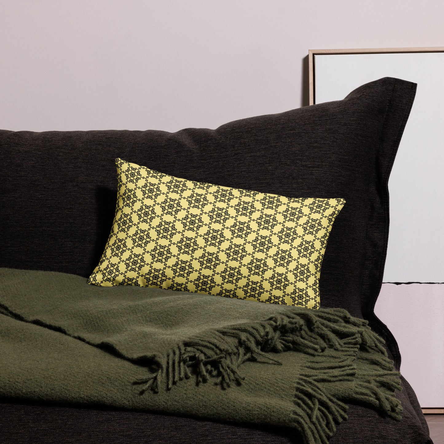 20″×12″ premium throw pillow with the 'Hexagon' yellow and black geometric pattern on a couch.