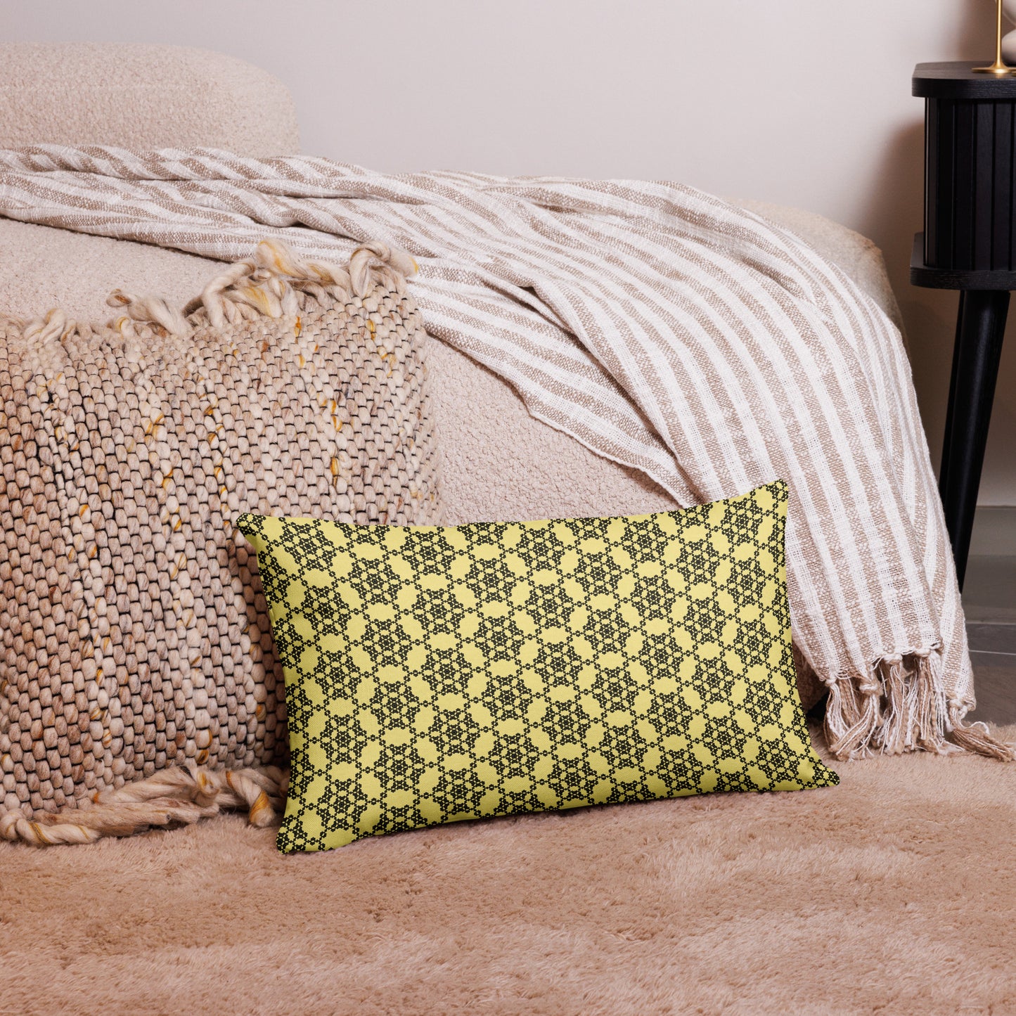 20″×12″ premium throw pillow with the 'Hexagon' yellow and black geometric pattern on a couch.