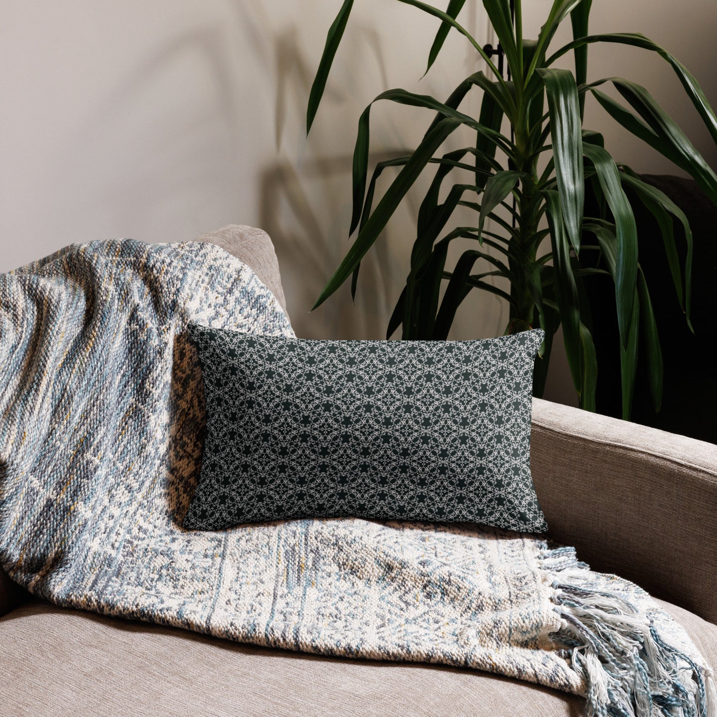 20″×12″ premium throw pillow with the 'Tetragon' charcoal and white geometric pattern on a couch.