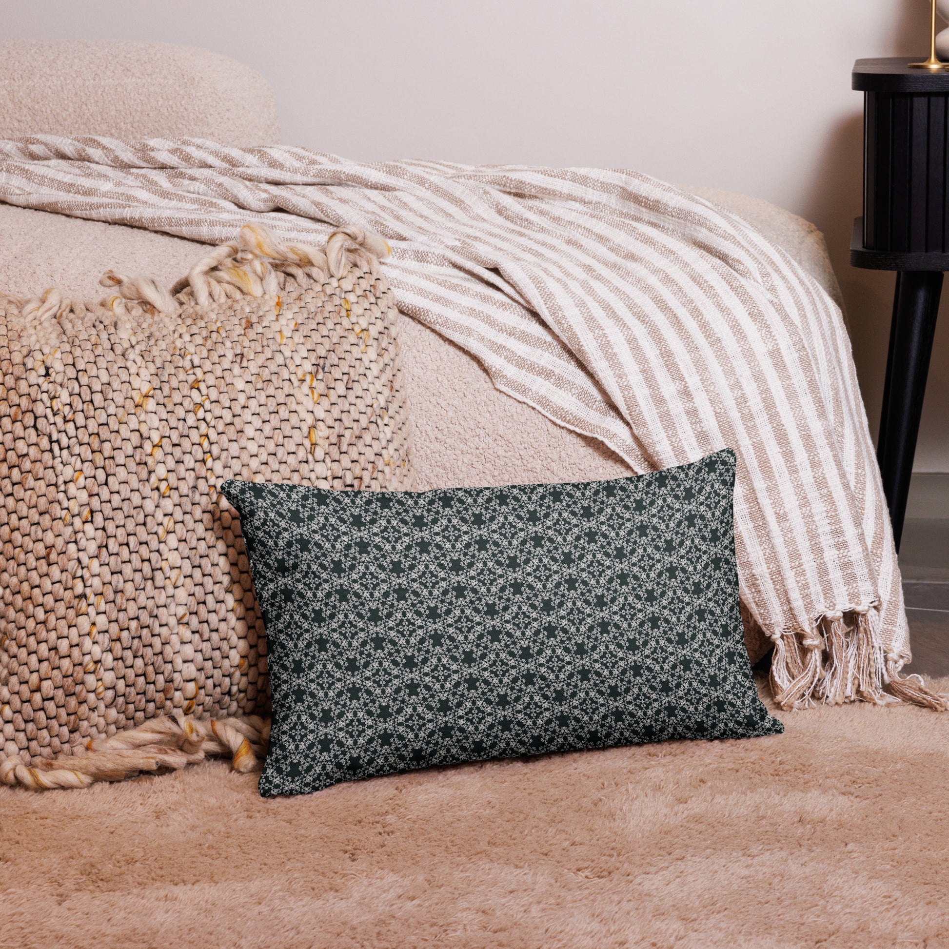 20″×12″ premium throw pillow with the 'Tetragon' charcoal and white geometric pattern on a couch.