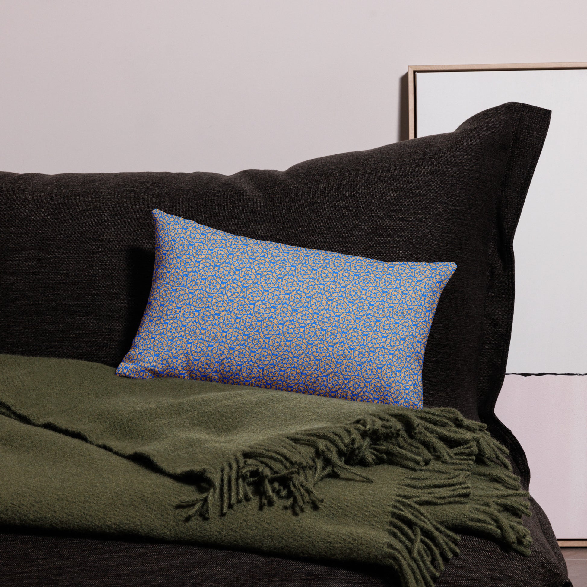 20″×12″ premium throw pillow with the 'Pentagon' blue and yellow geometric pattern on a couch.