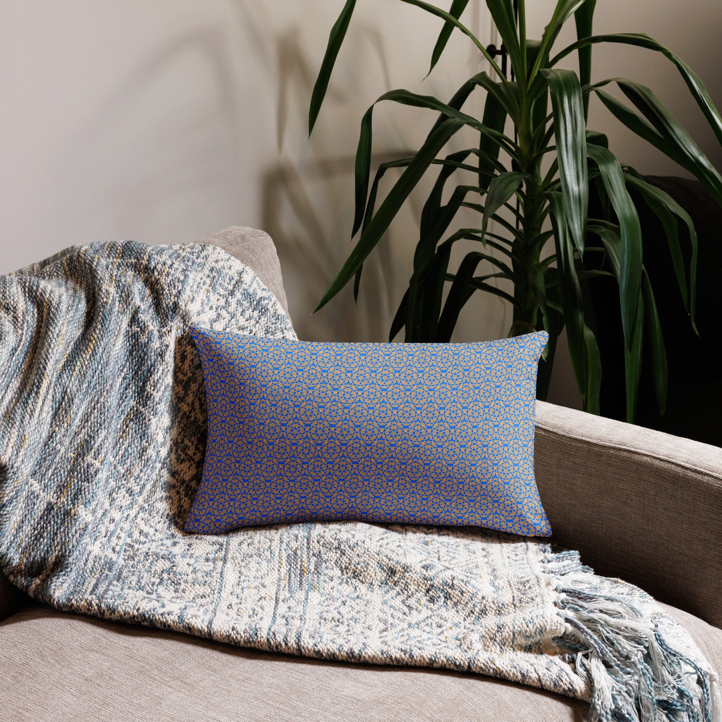 20″×12″ premium throw pillow with the 'Pentagon' blue and yellow geometric pattern on a couch.