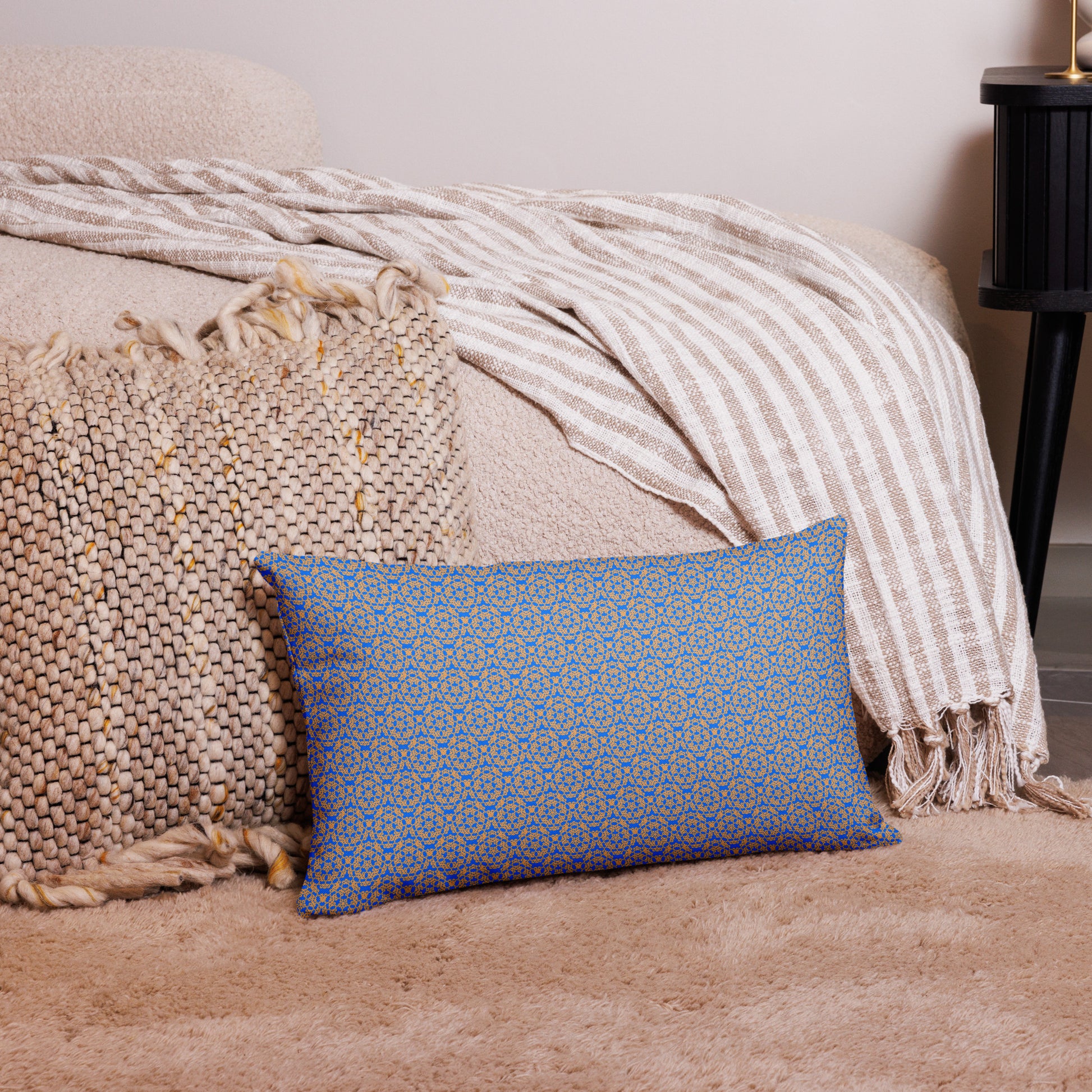 20″×12″ premium throw pillow with the 'Pentagon' blue and yellow geometric pattern on a couch.