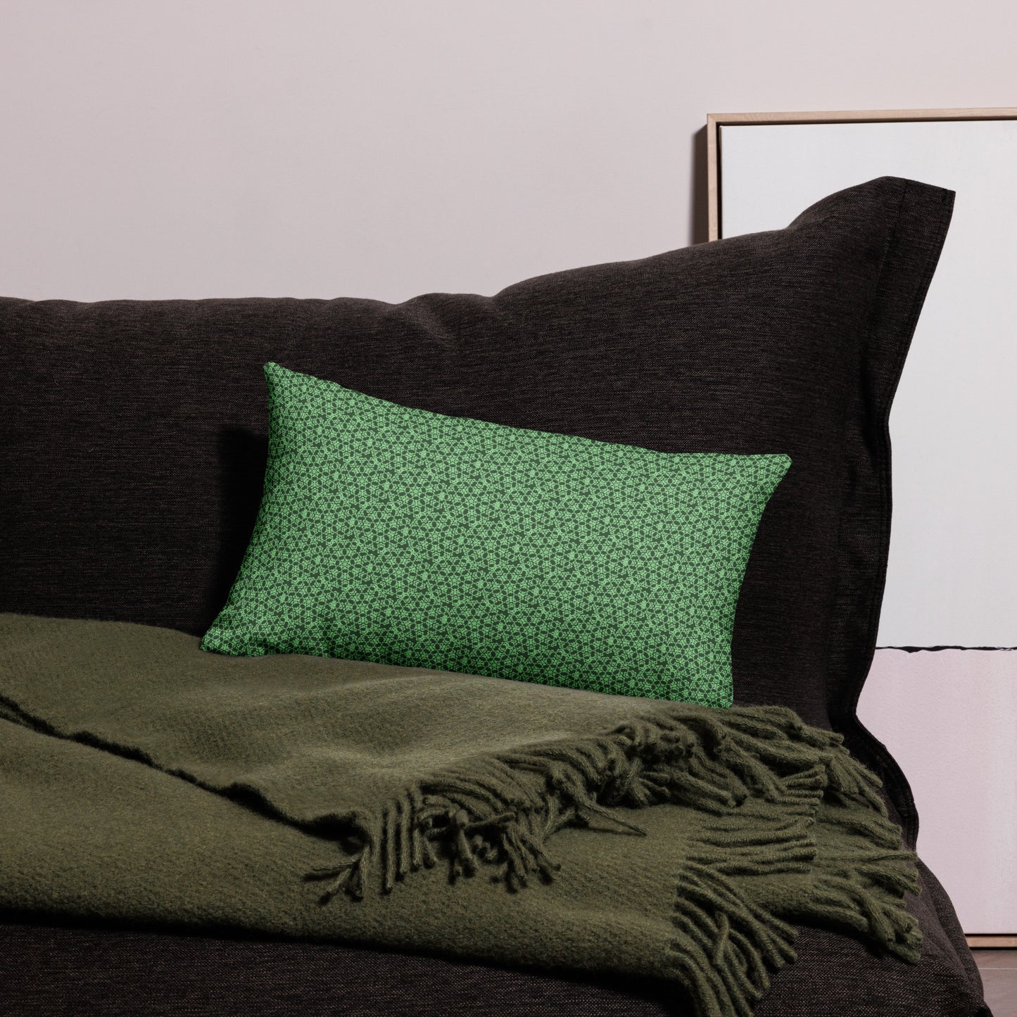 20″×12″ premium throw pillow with the 'Heptagon' green geometric pattern on a couch.