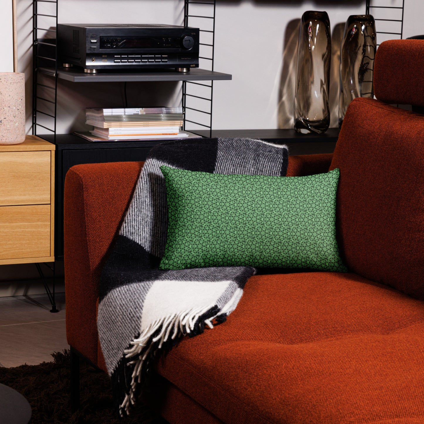 20″×12″ premium throw pillow with the 'Heptagon' green geometric pattern on a couch.
