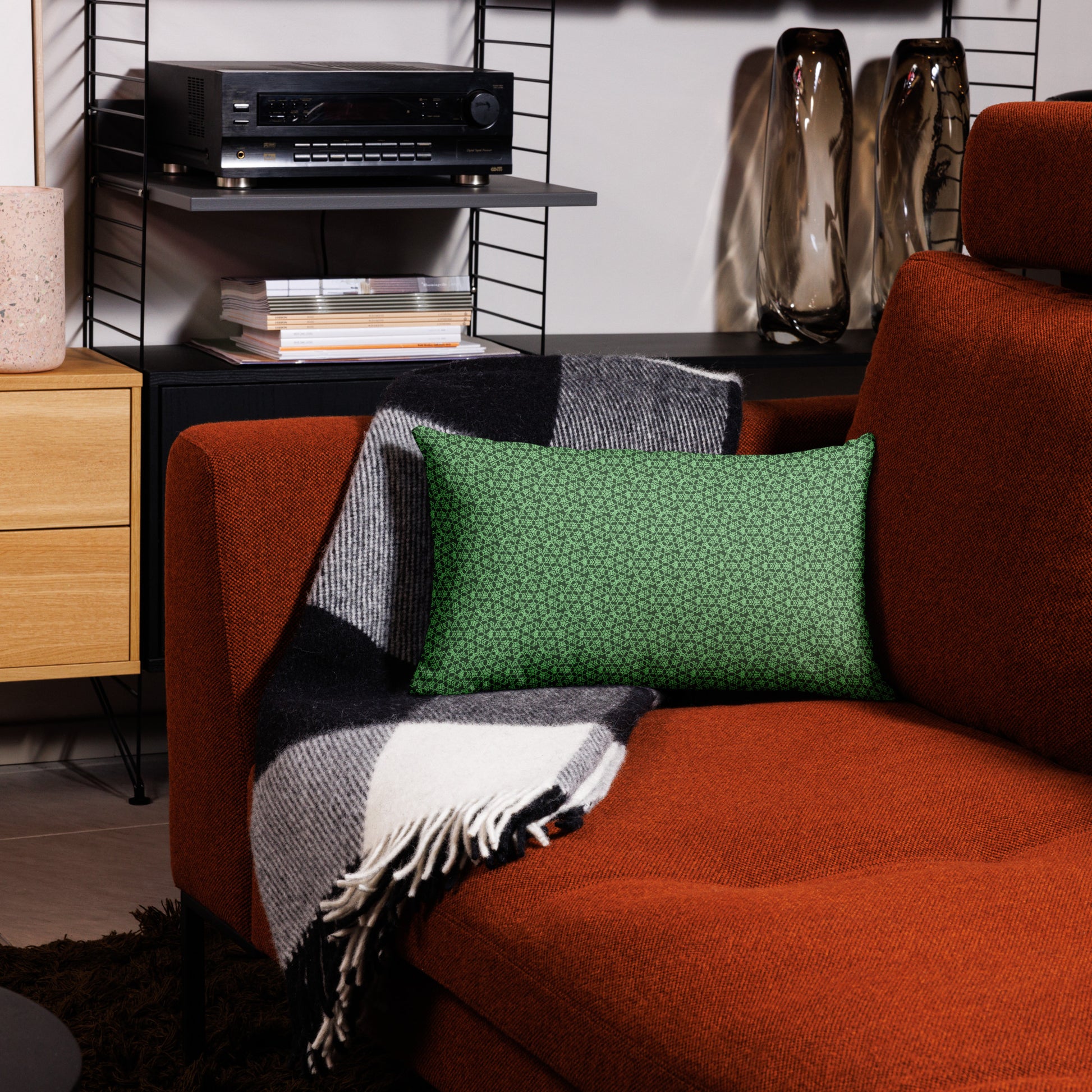 20″×12″ premium throw pillow with the 'Heptagon' green geometric pattern on a couch.