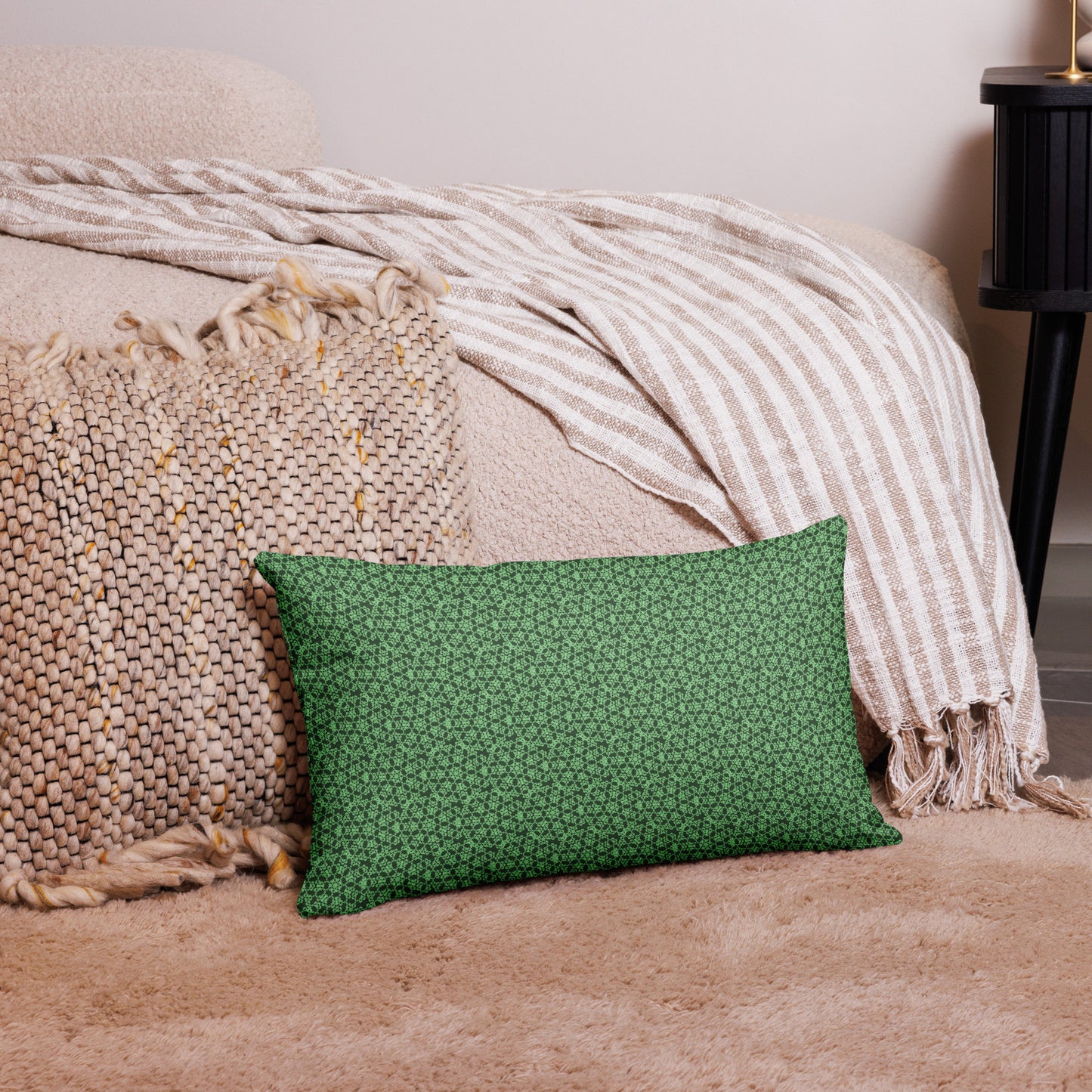 20″×12″ premium throw pillow with the 'Heptagon' green geometric pattern on a couch.