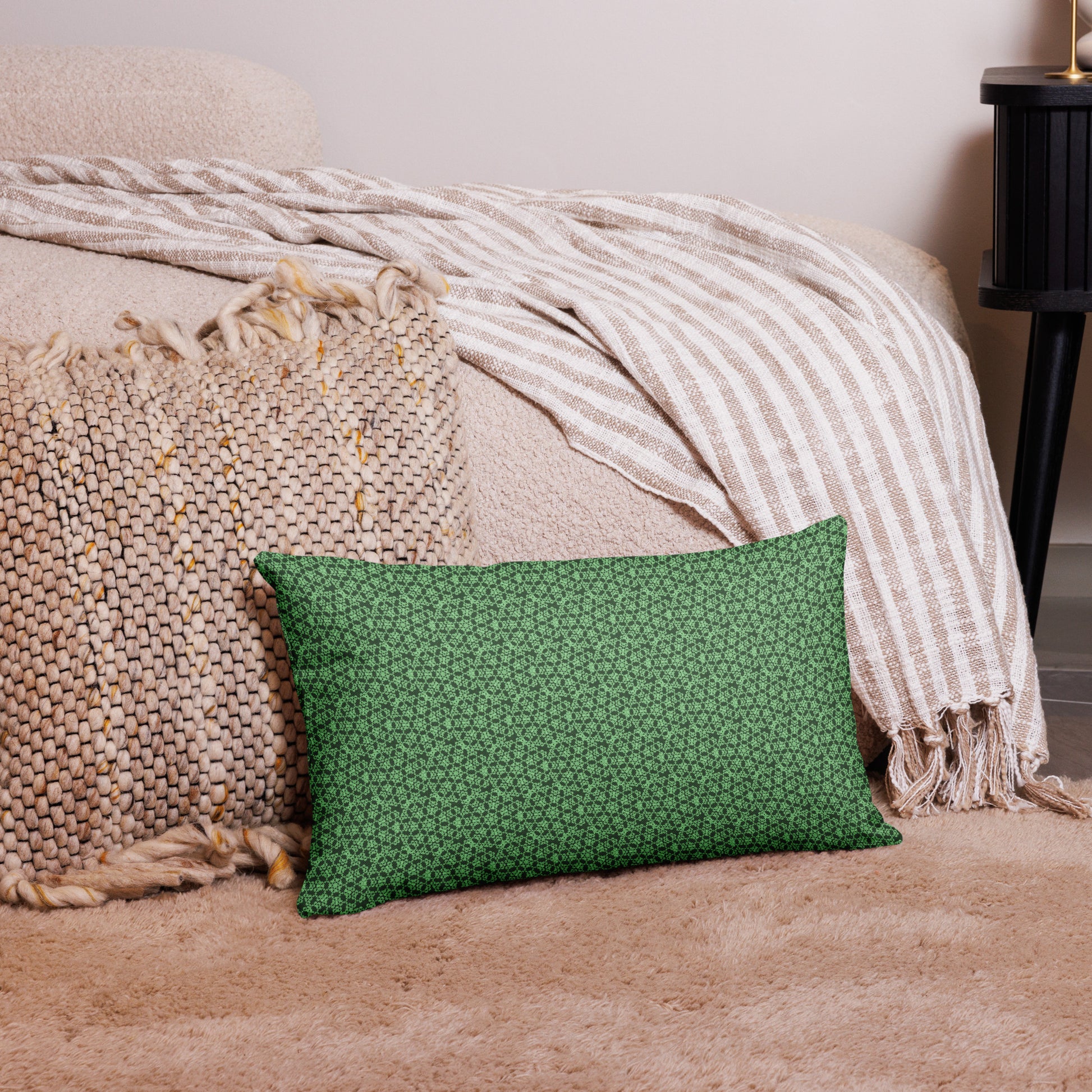 20″×12″ premium throw pillow with the 'Heptagon' green geometric pattern on a couch.