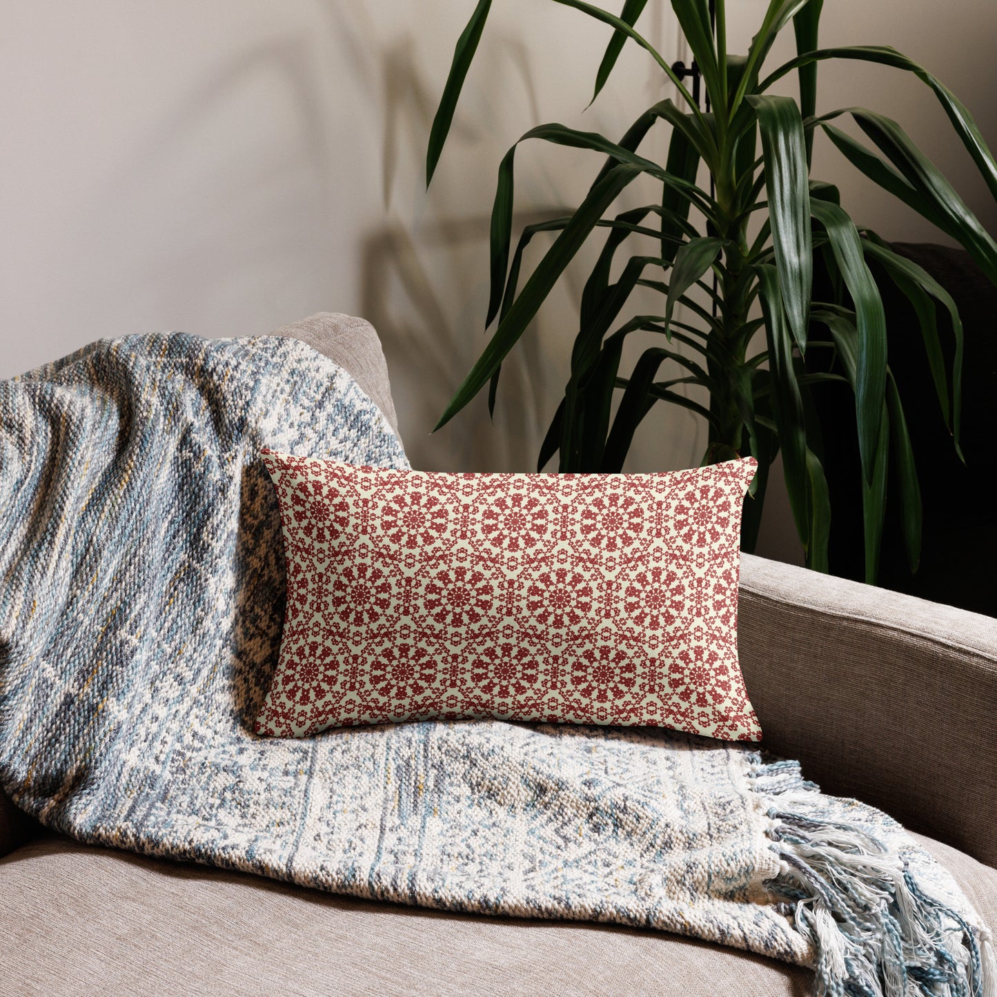 20″×12″ premium throw pillow with the ‘Decagon’ terracotta and beige geometric pattern on a beige sofa with a woven throw.