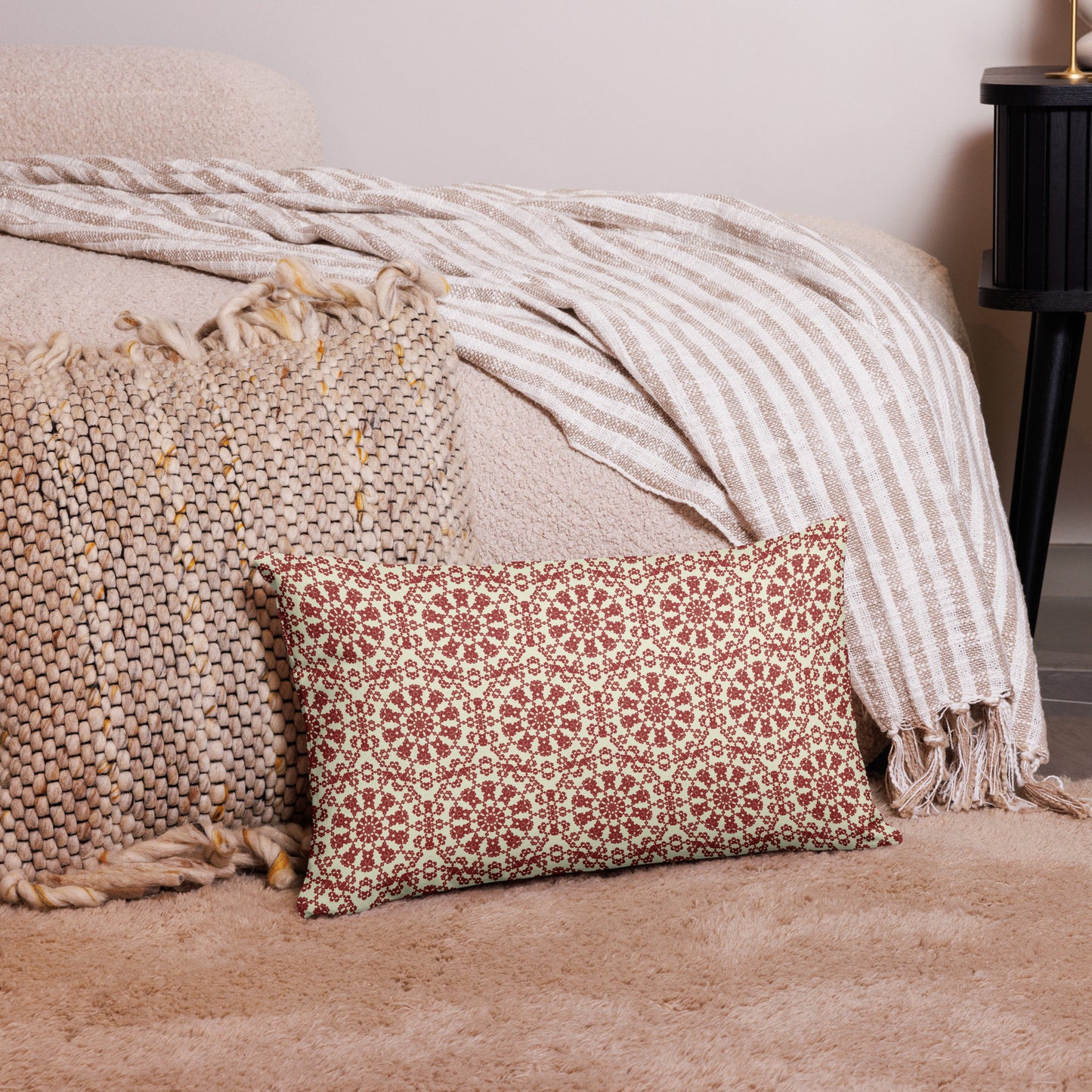 20″×12″ premium throw pillow with the ‘Decagon’ terracotta and beige geometric pattern on a bedroom floor with striped linen throws.