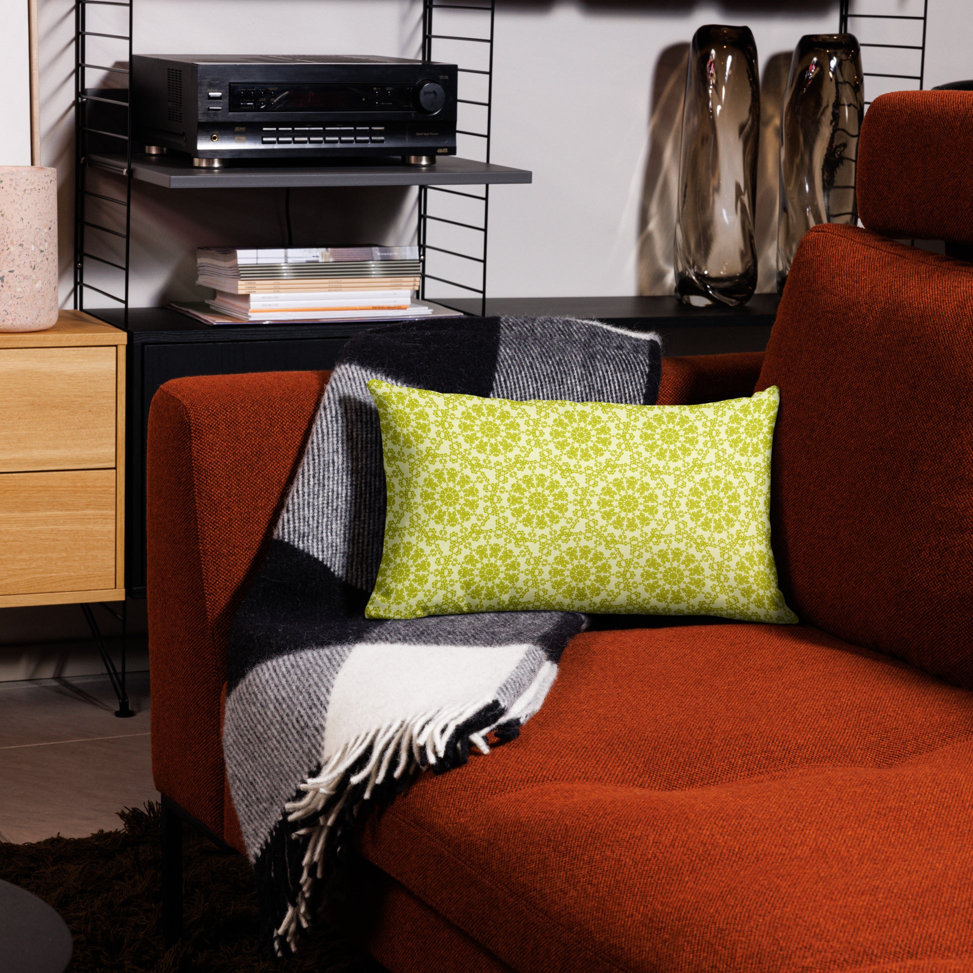 20″×12″ premium throw pillow with the 'Hendecagon' yellow-green geometric pattern on a terracotta sofa in a modern living room
