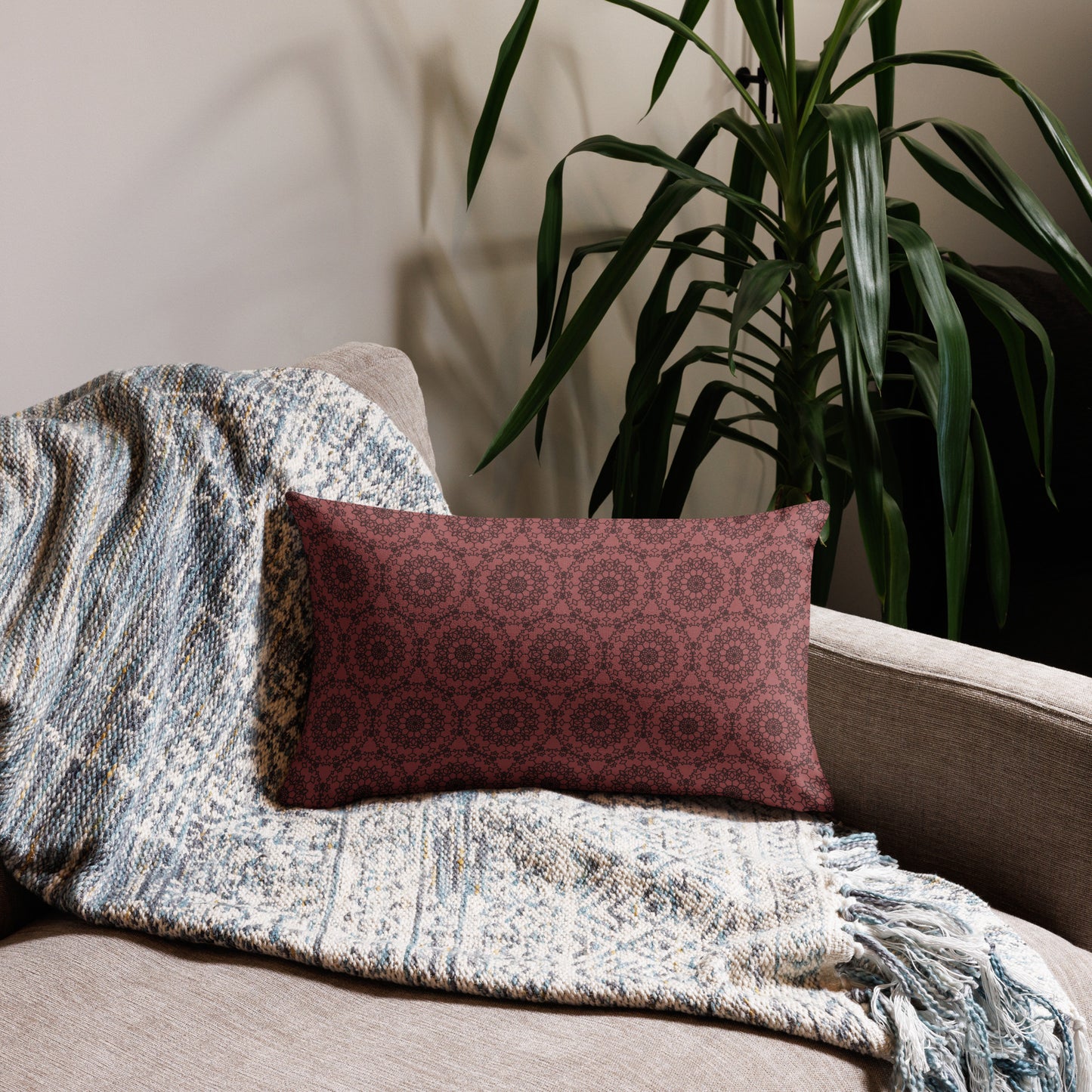20″×12″ premium throw pillow with the 'Dodecagon' rose geometric pattern on beige sofa with woven throw blanket.